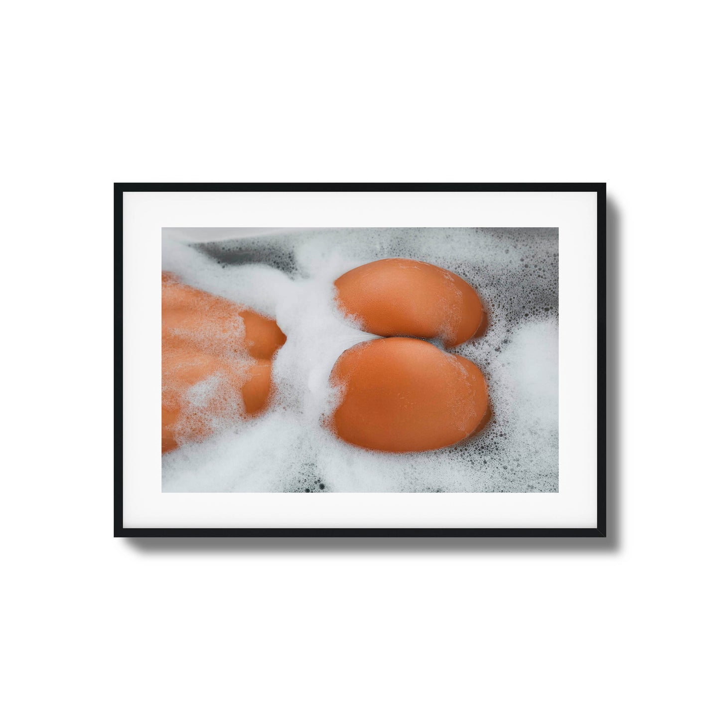 Close-up of skin and foam in a bathtub.