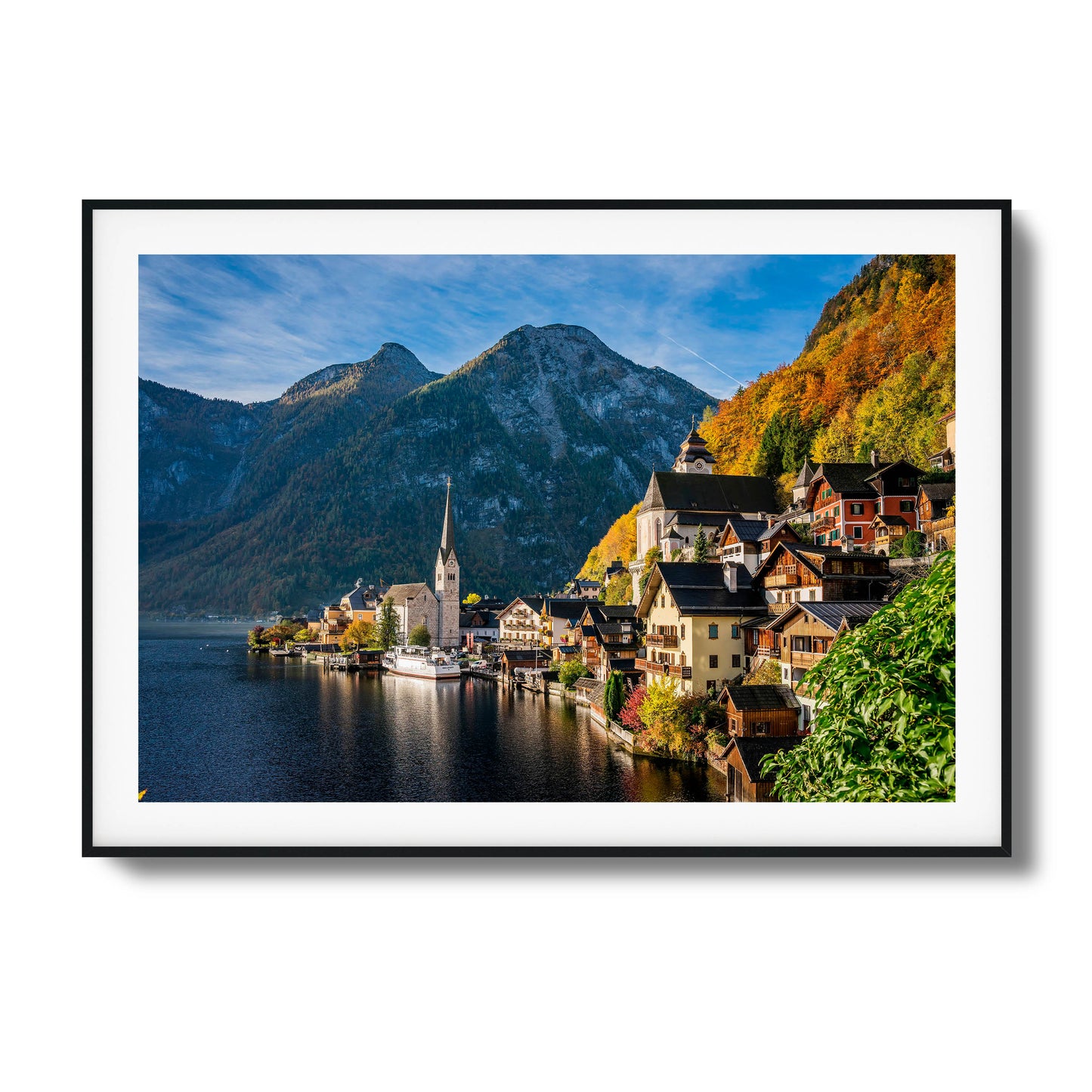 Picturesque lakeside village with mountains and autumn foliage