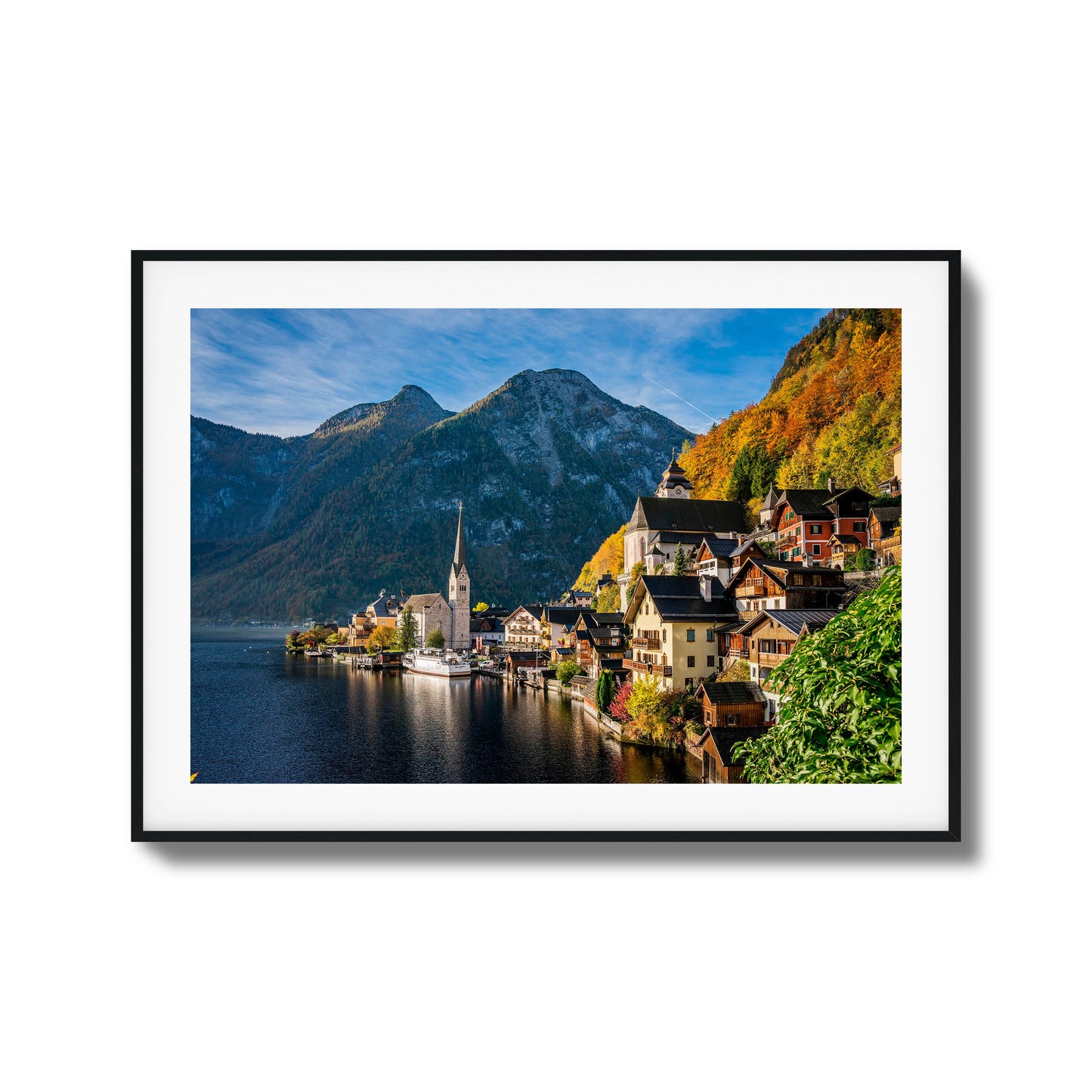 Picturesque lakeside village with mountains and autumn foliage