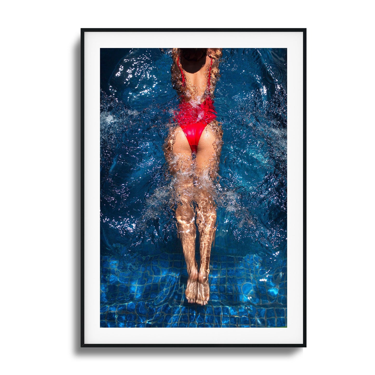 Swimmer in a red swimsuit diving into water, with dynamic splashes of water, representing grace and motion.