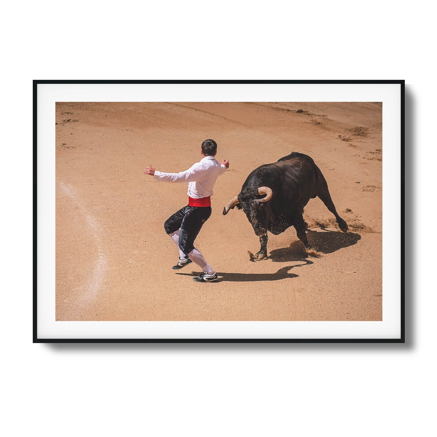 Bullfighter in action with a charging bull