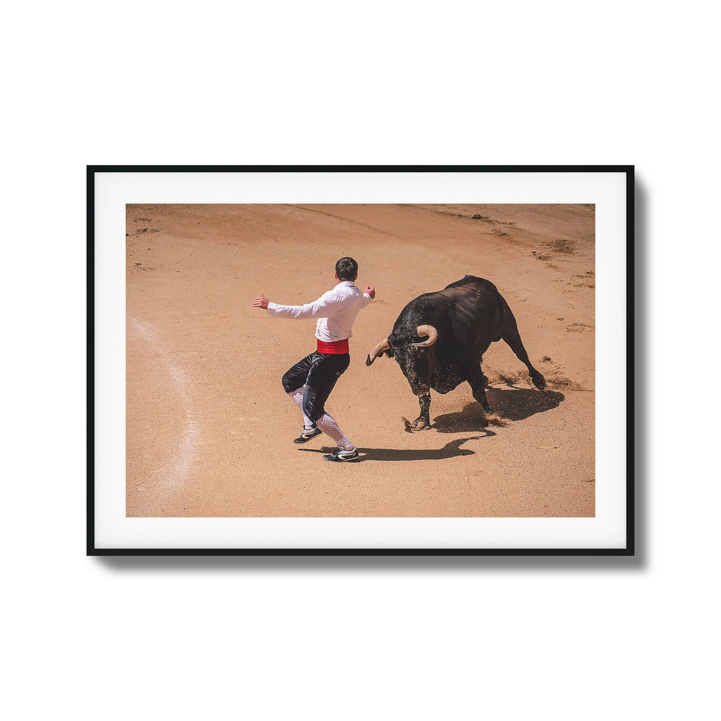 Bullfighter in action with a charging bull