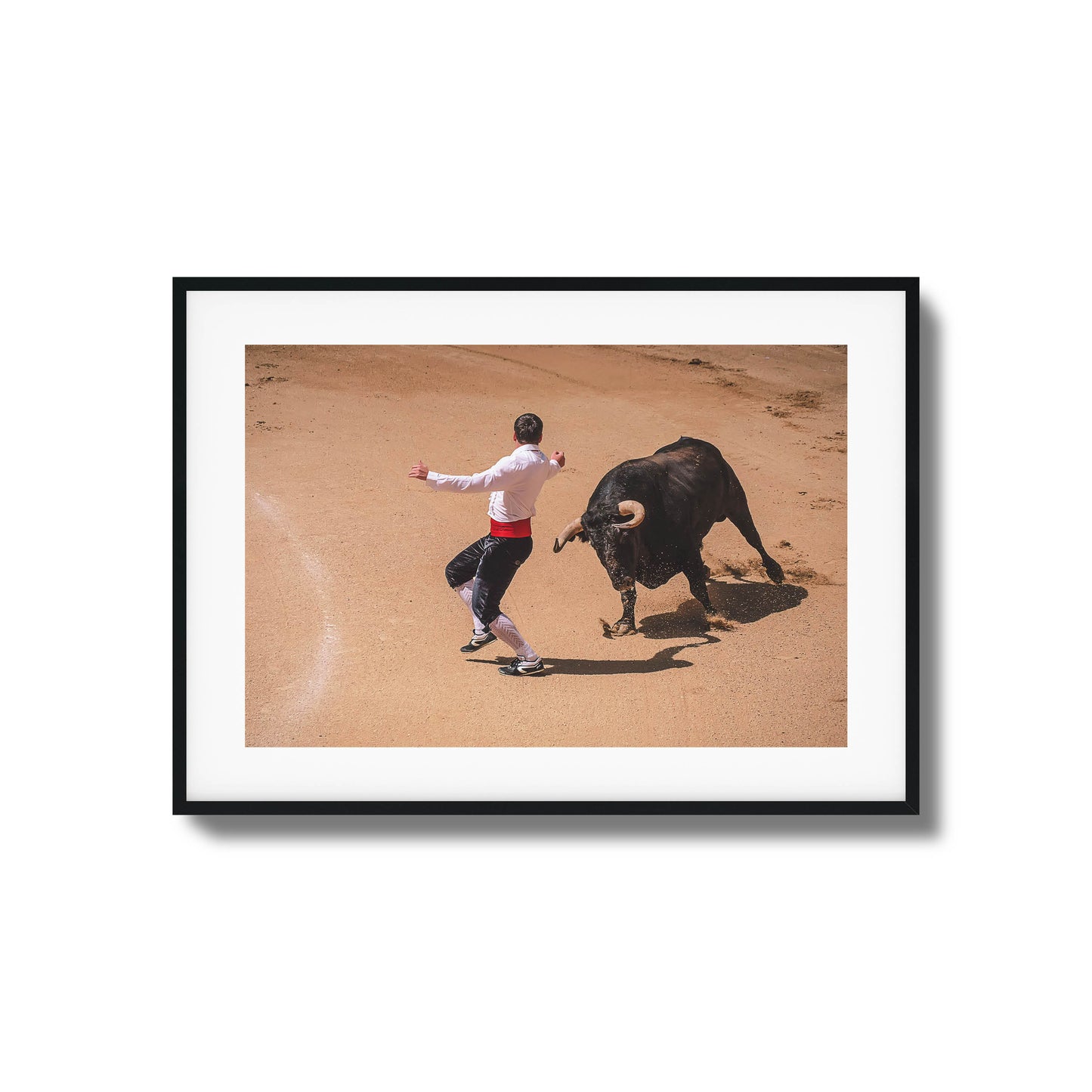 Bullfighter in action with a charging bull