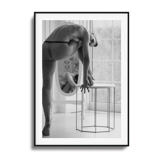 Black and white photo of a contorted figure in fishnet attire.