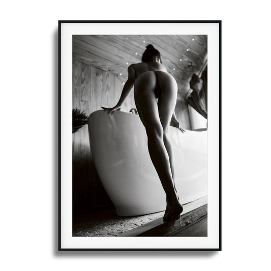 Woman by the bath, minimalist black and white art in a premium frame.