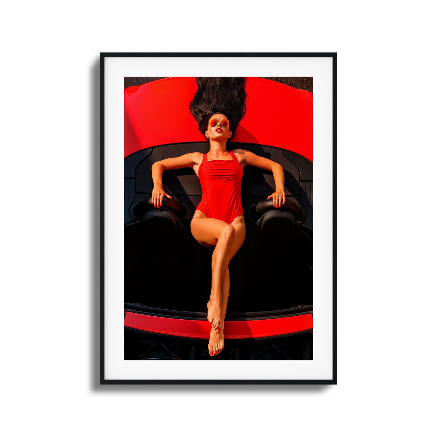 Woman in red swimsuit reclining on a red car framed art