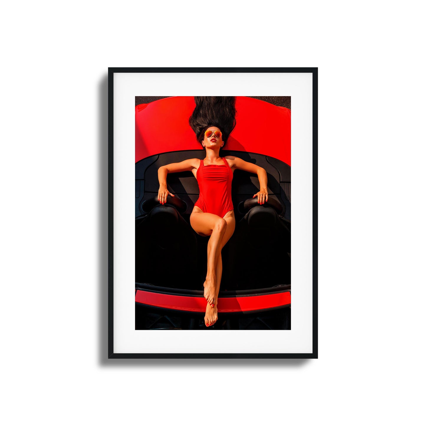 Woman in red swimsuit reclining on a red car framed art