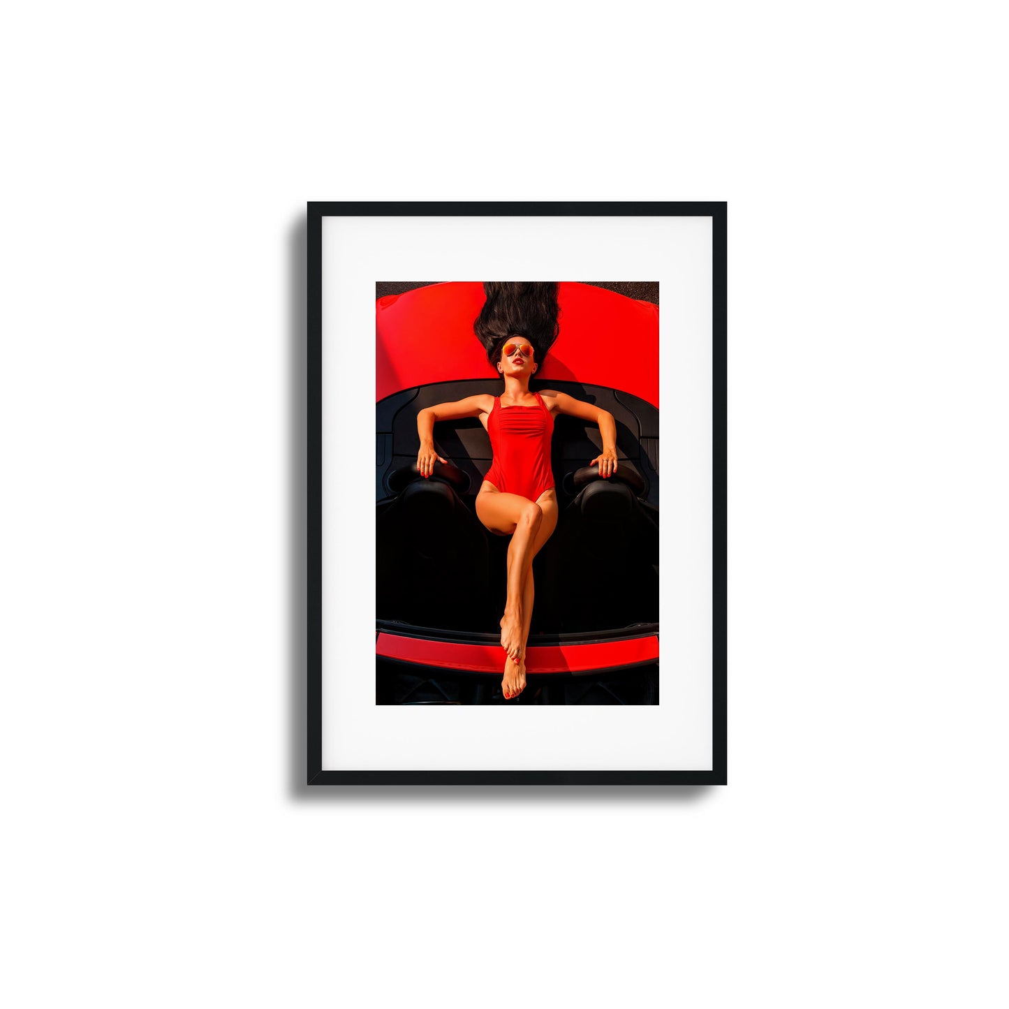 Woman in red swimsuit reclining on a red car framed art