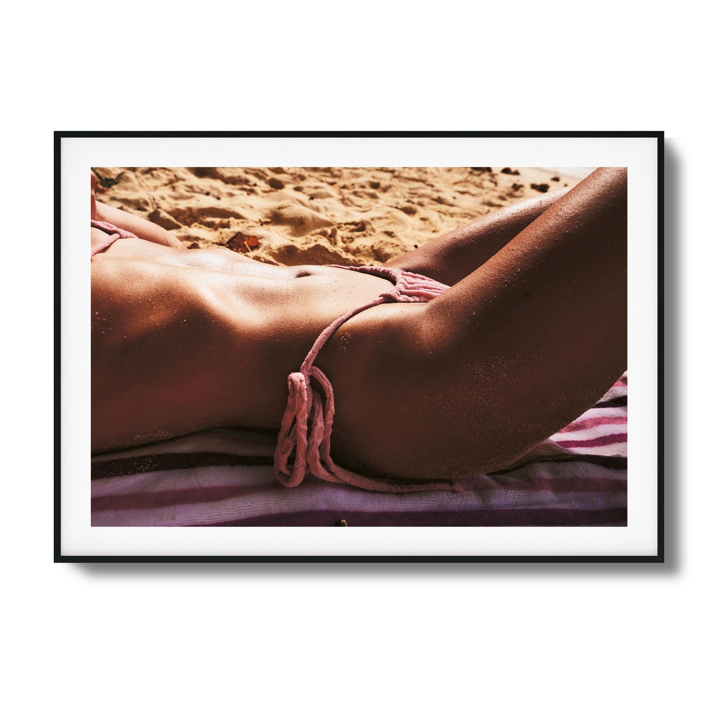 Relaxing sun-kissed skin on beach towel.