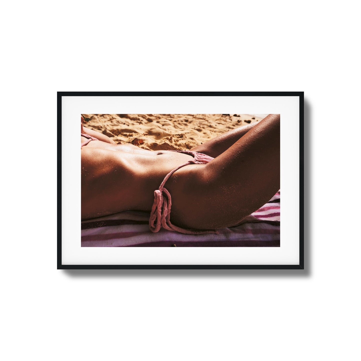 Relaxing sun-kissed skin on beach towel.