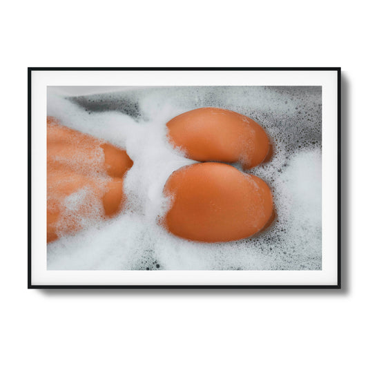 Close-up of skin and foam in a bathtub.