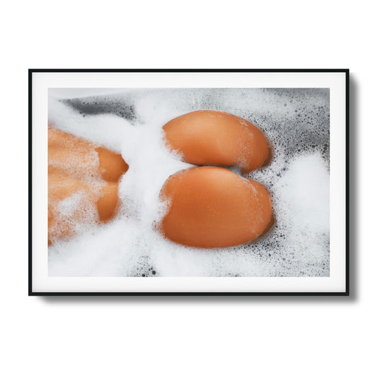 Close-up of skin and foam in a bathtub.