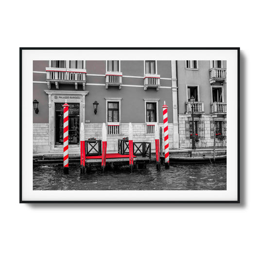 Venetian dock with striped poles and waterfront charm.