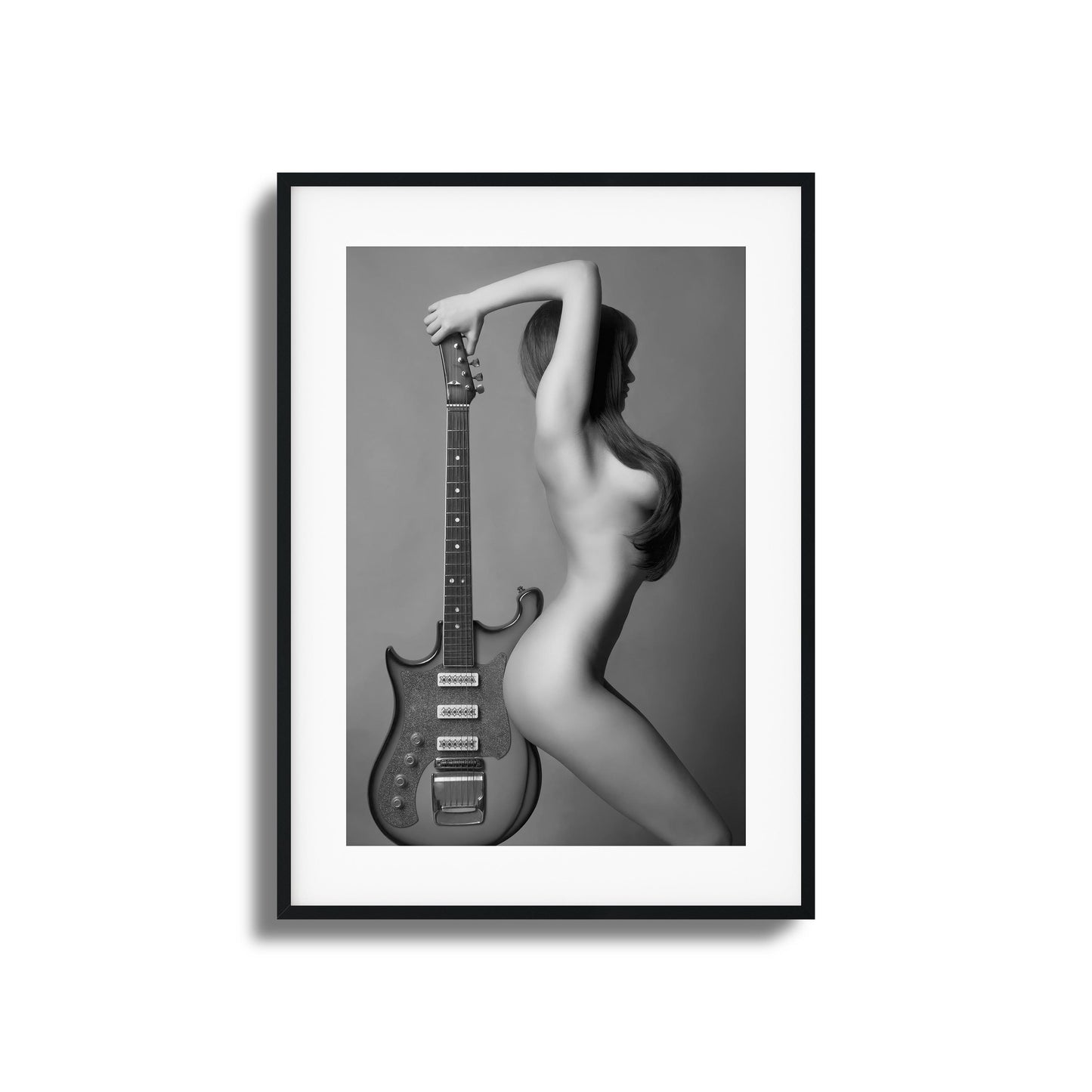 Artistic black-and-white image of a figure with a guitar