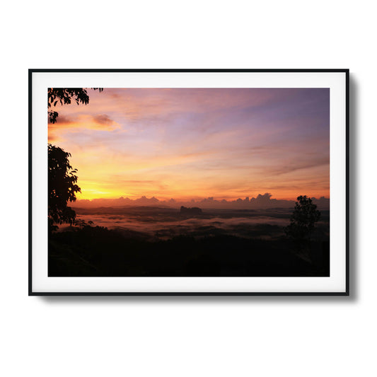 Cloud-covered valley illuminated by soft pastel hues of dawn, perfect for serene framed wall art.