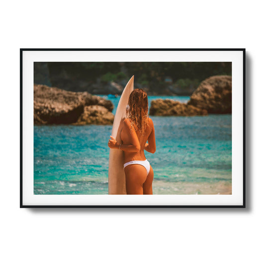 Woman holding a surfboard by the ocean