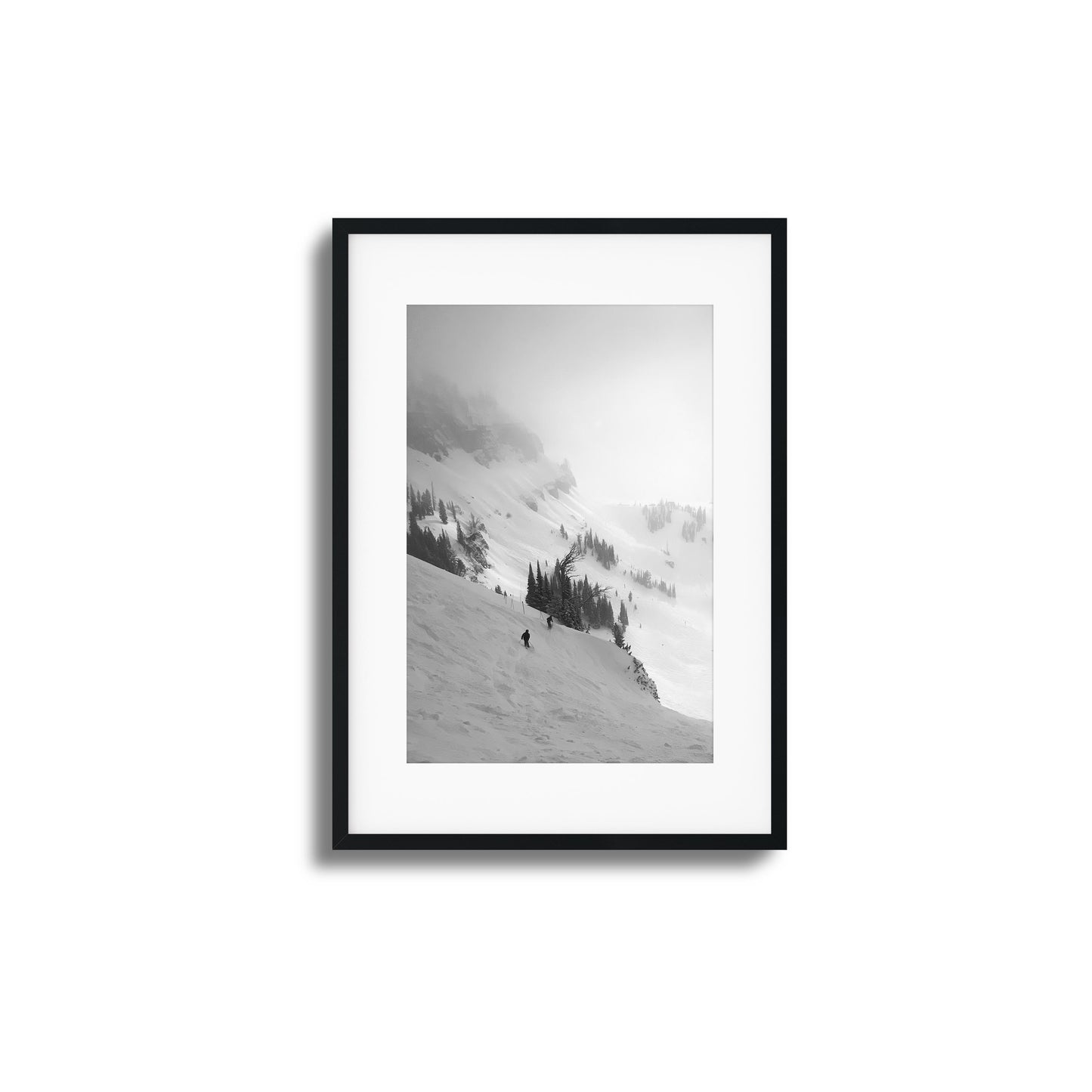 Black-and-white skiers on misty mountain framed art