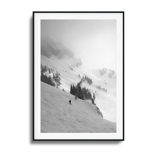 Black-and-white skiers on misty mountain framed art