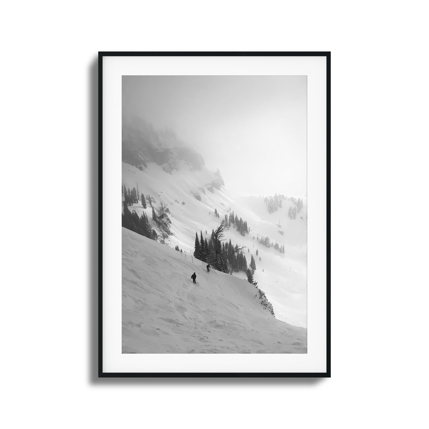 Black-and-white skiers on misty mountain framed art