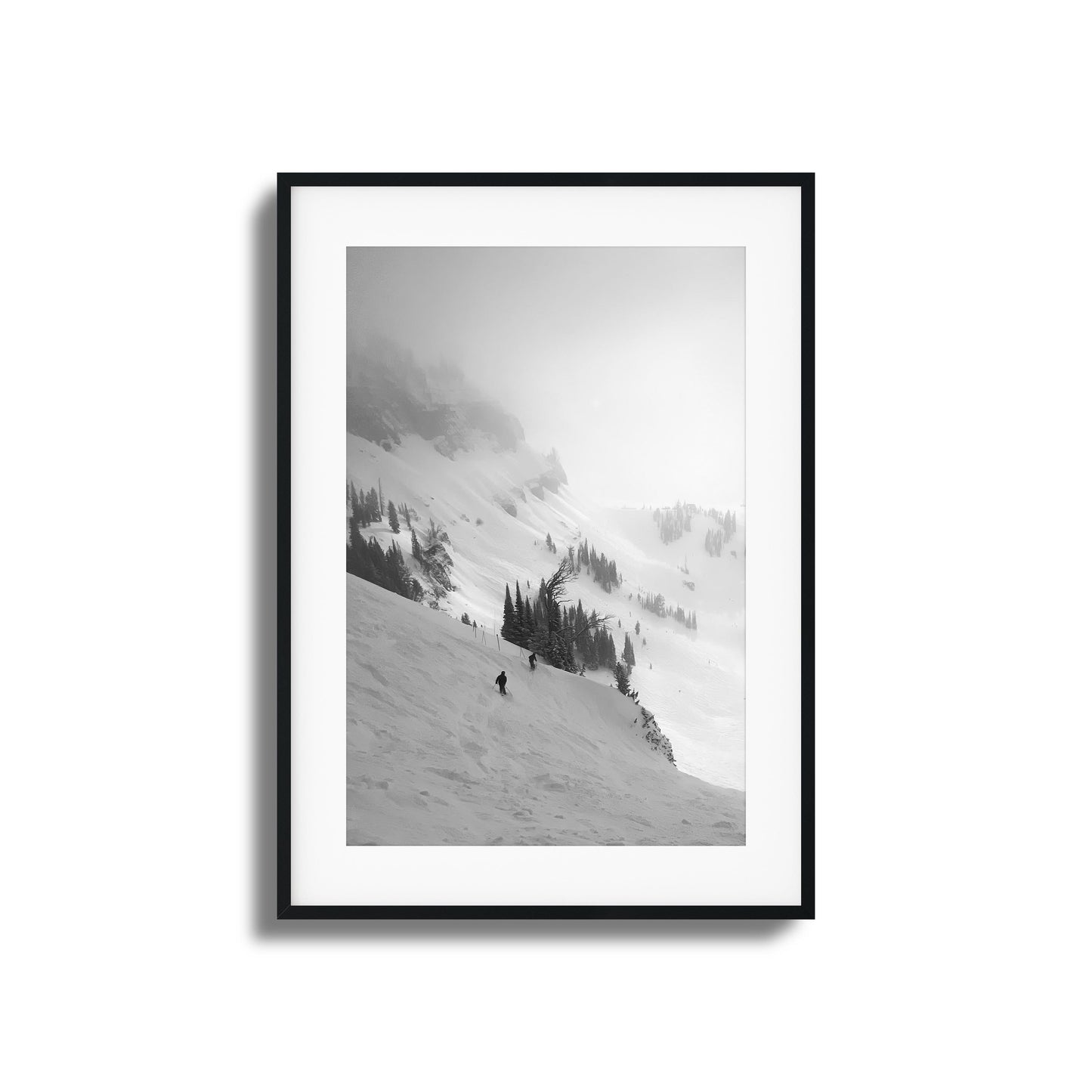 Black-and-white skiers on misty mountain framed art