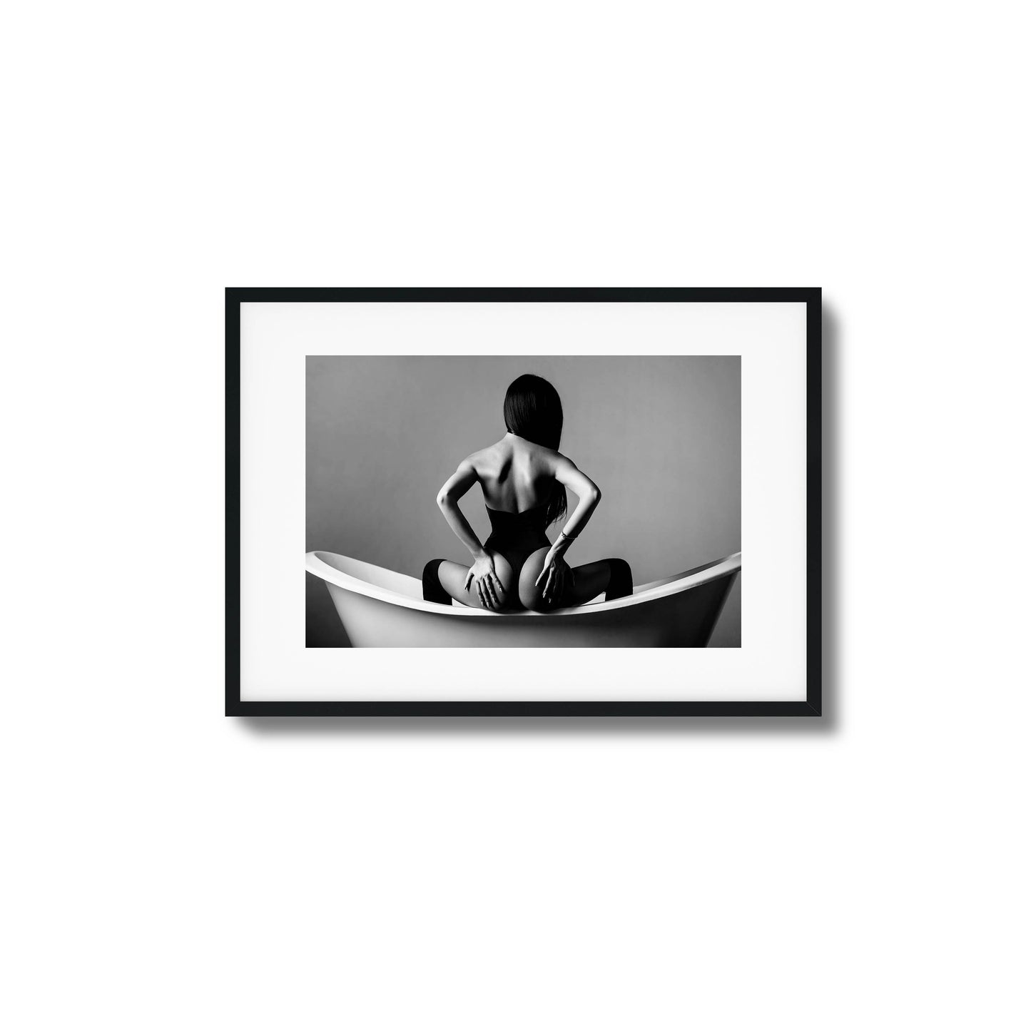 Woman sitting in a bathtub in monochrome