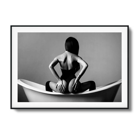 Woman sitting in a bathtub in monochrome