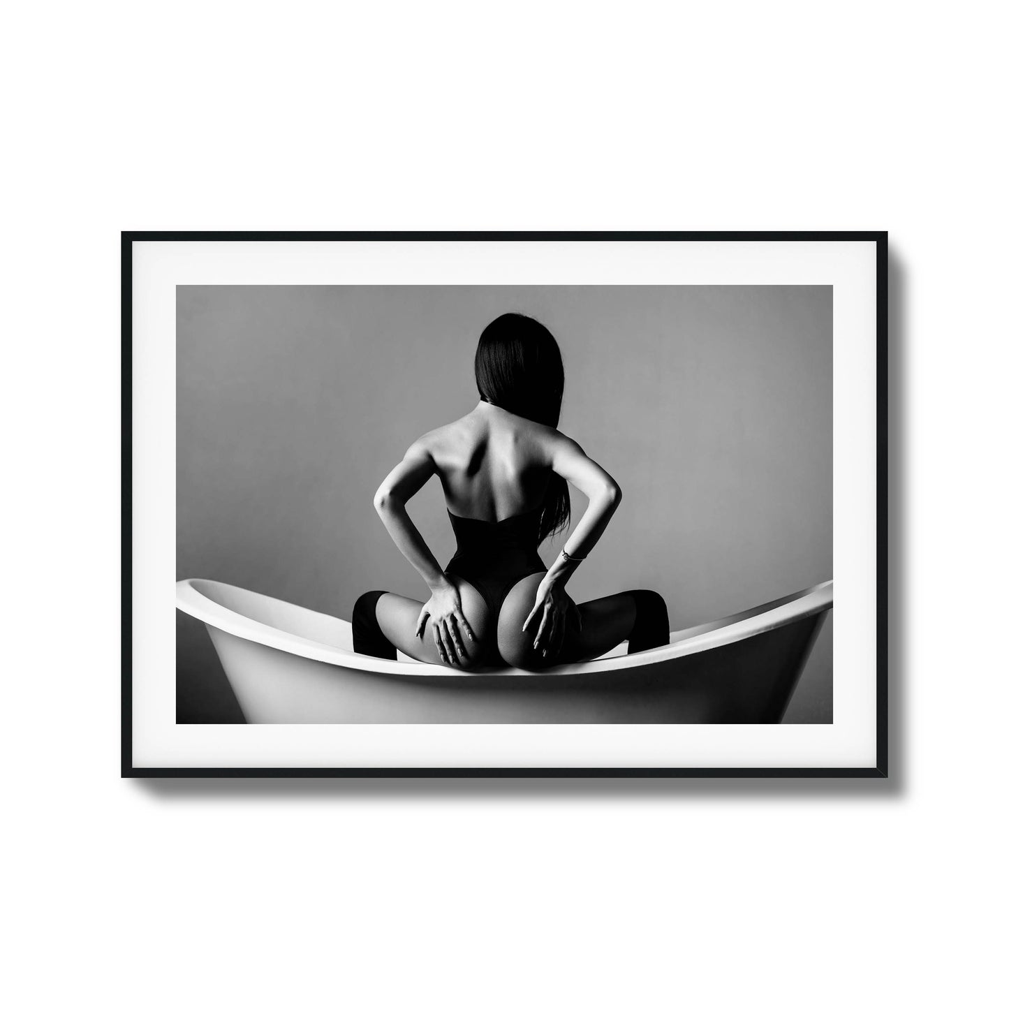 Woman sitting in a bathtub in monochrome