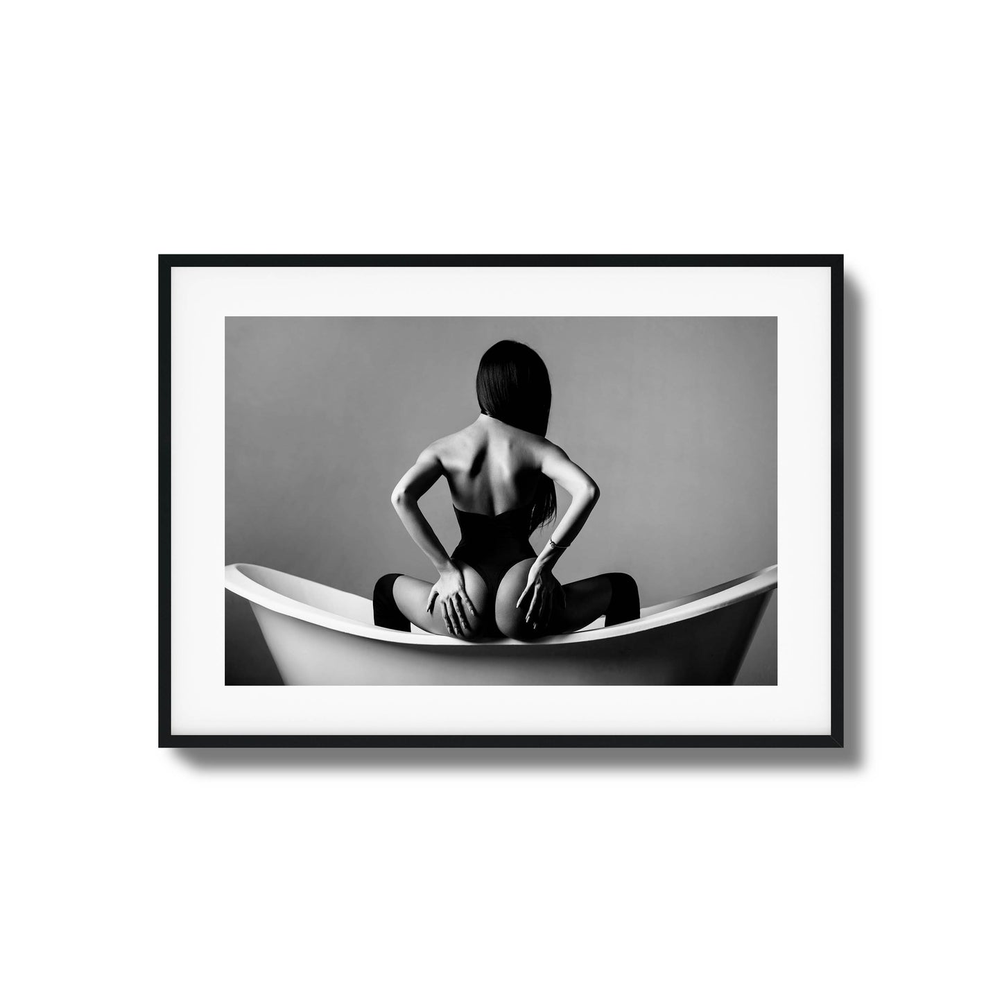 Woman sitting in a bathtub in monochrome