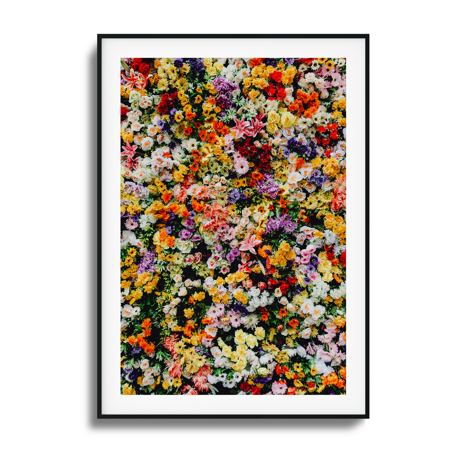 A vibrant wall of mixed colorful flowers in a stunning artistic composition.