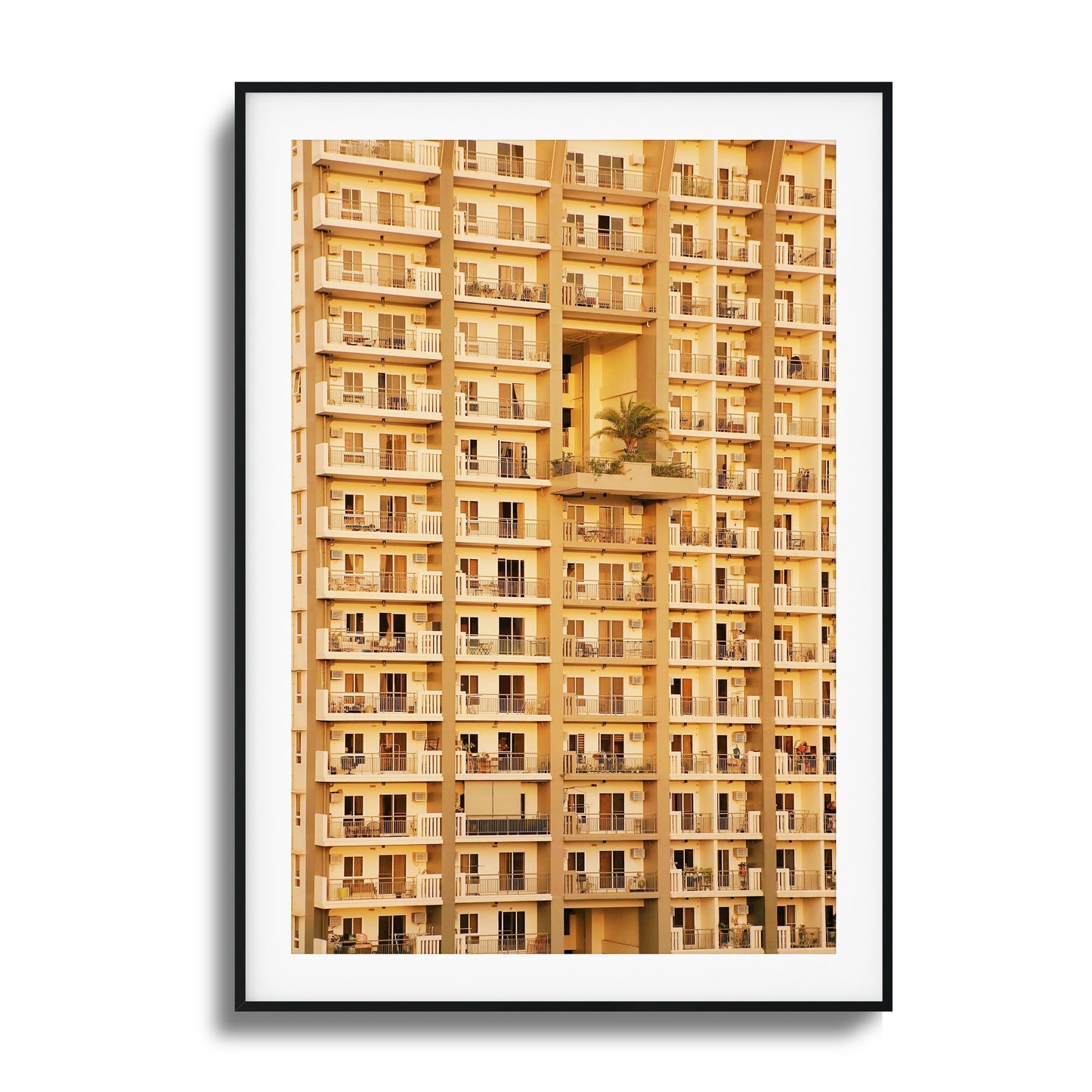 Golden apartment facade with symmetrical balconies.