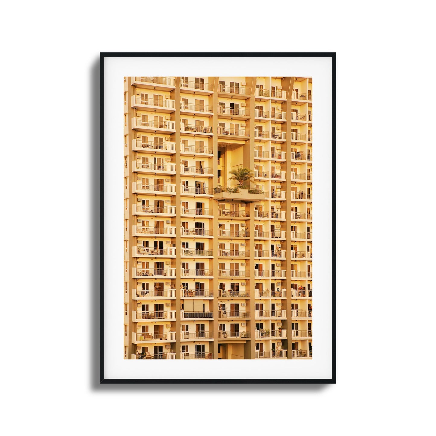 Golden apartment facade with symmetrical balconies.