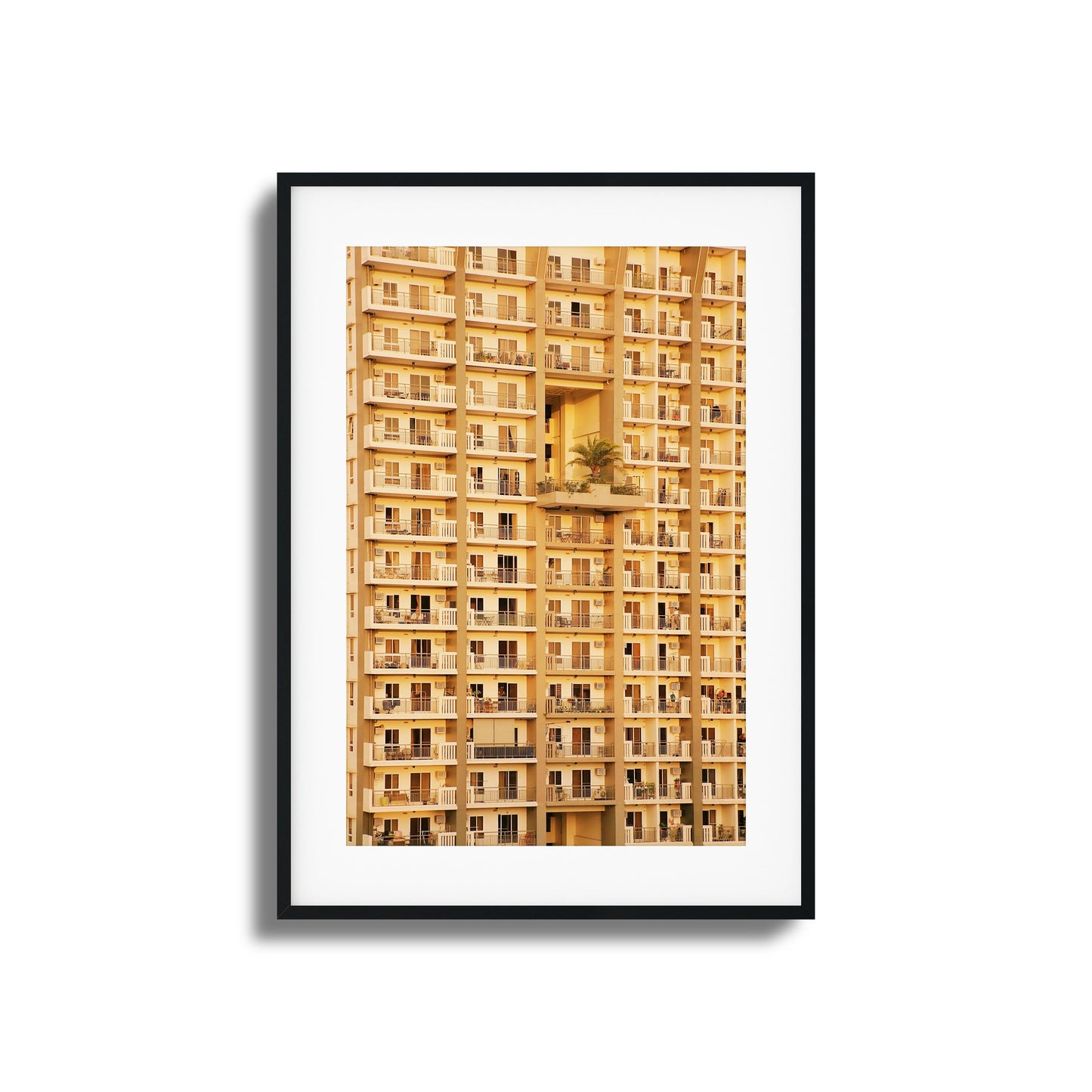 Golden apartment facade with symmetrical balconies.