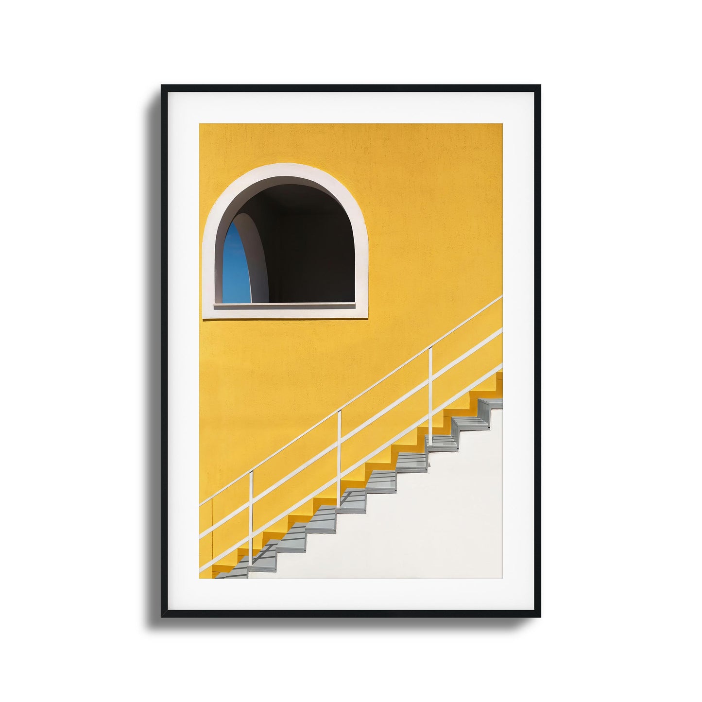 Bold yellow wall with stairs and an arched window.