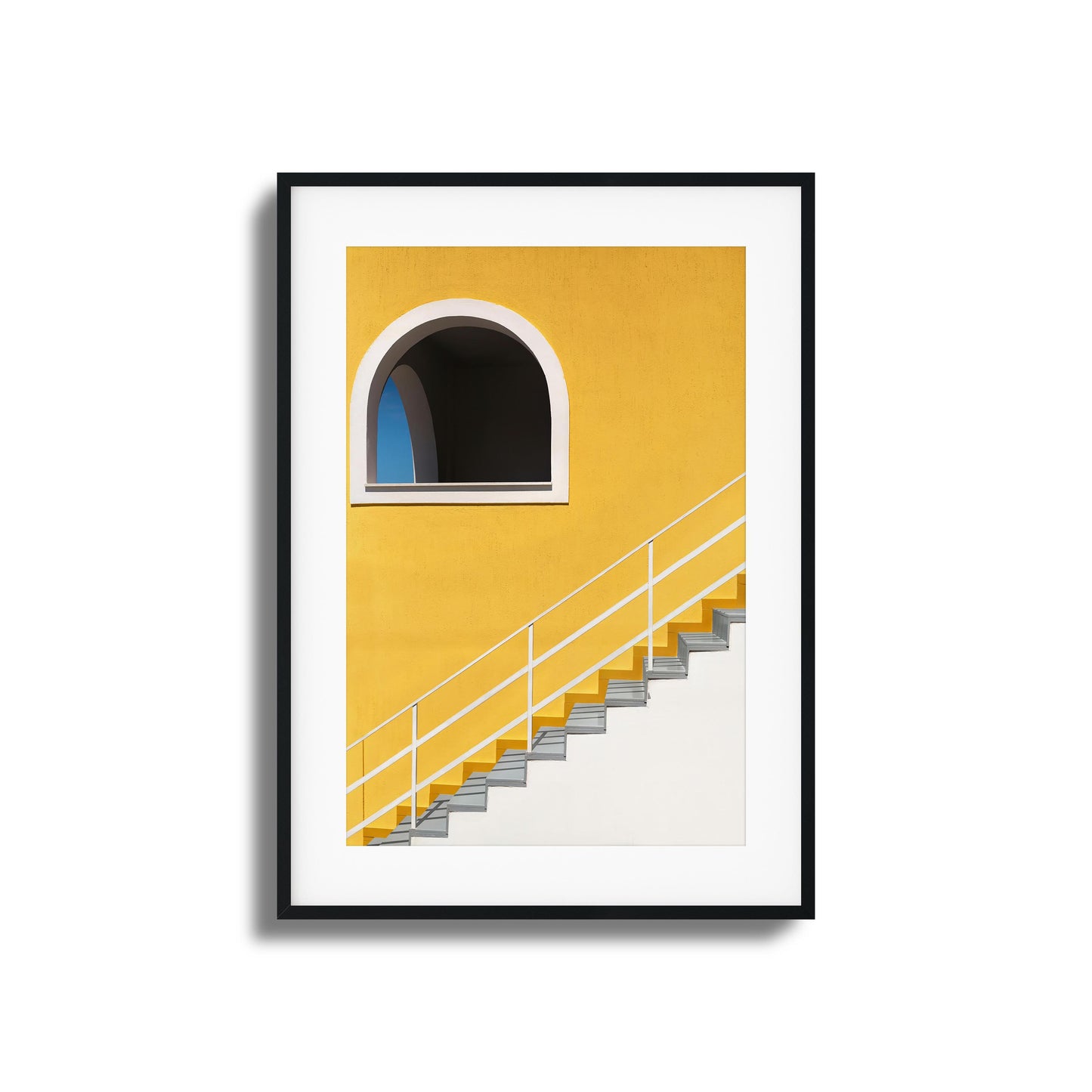 Bold yellow wall with stairs and an arched window.