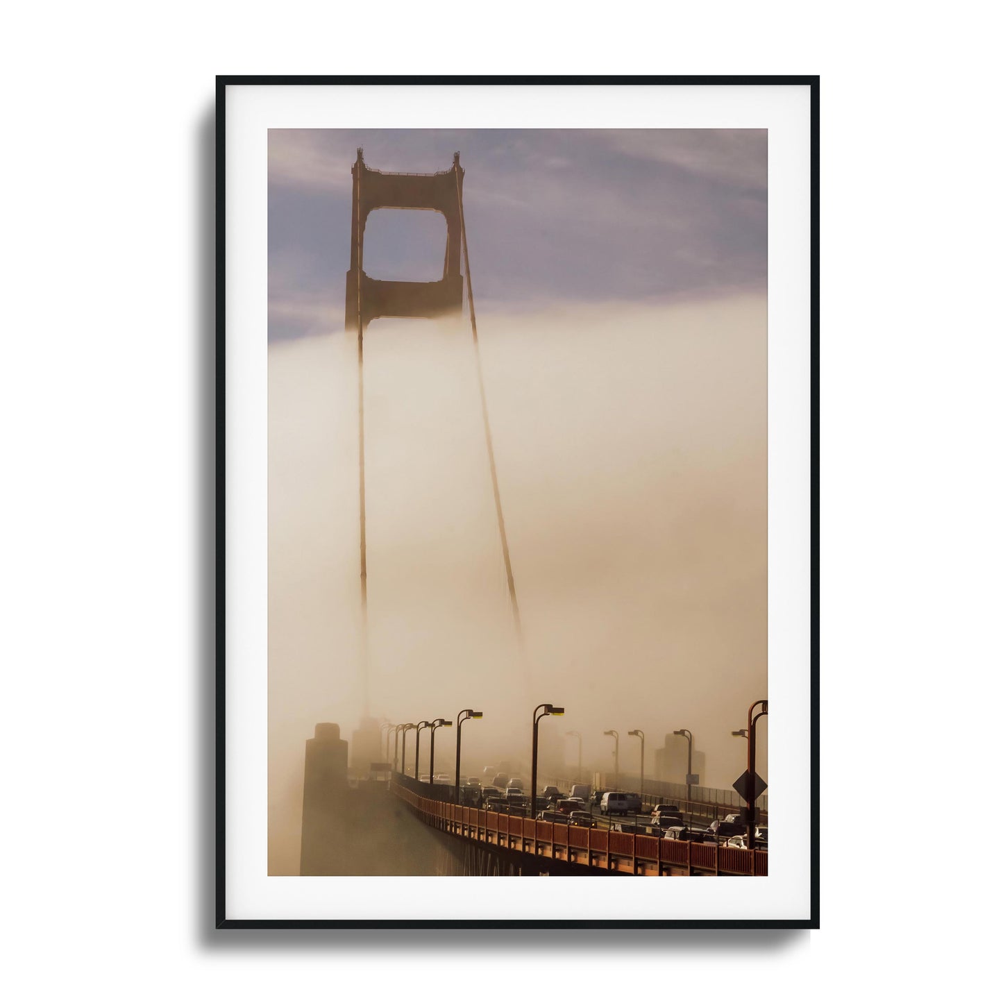 A moody photograph of the Golden Gate Bridge surrounded by dense fog, framed artwork.