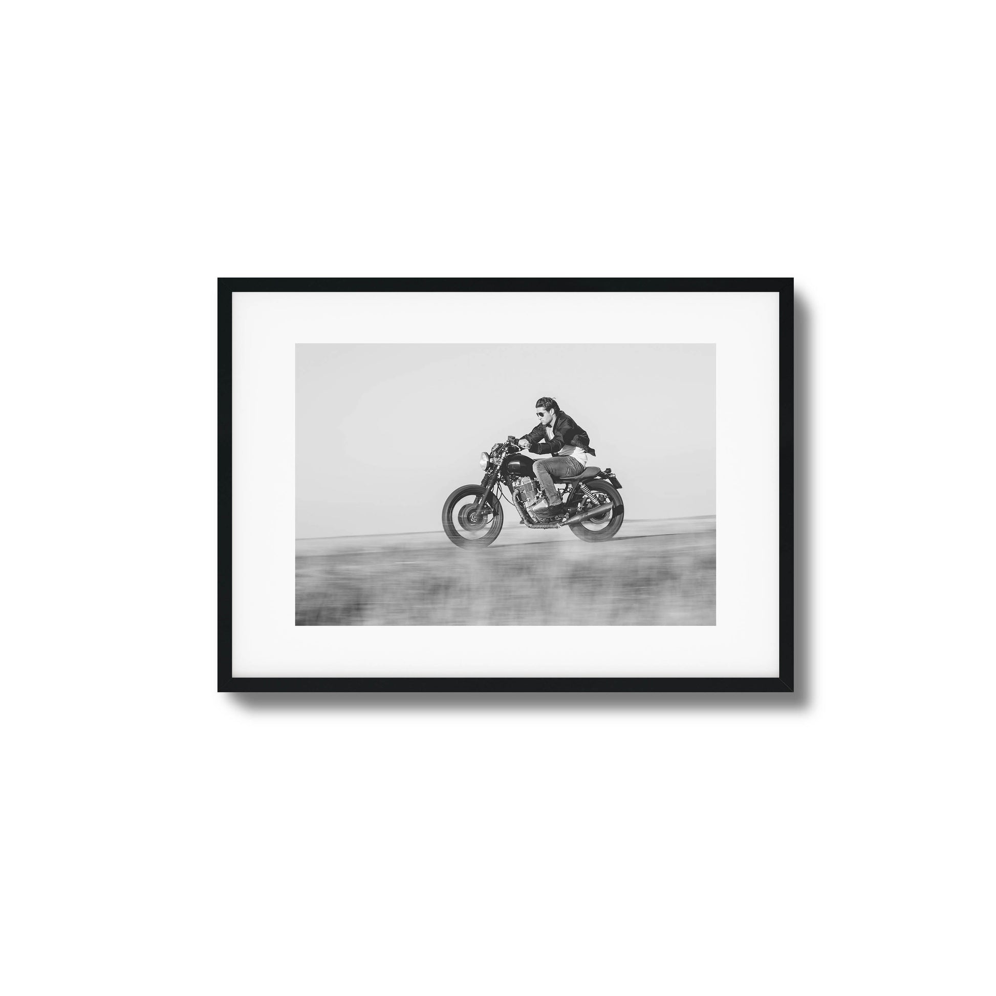 Black-and-white motorcyclist in motion framed art