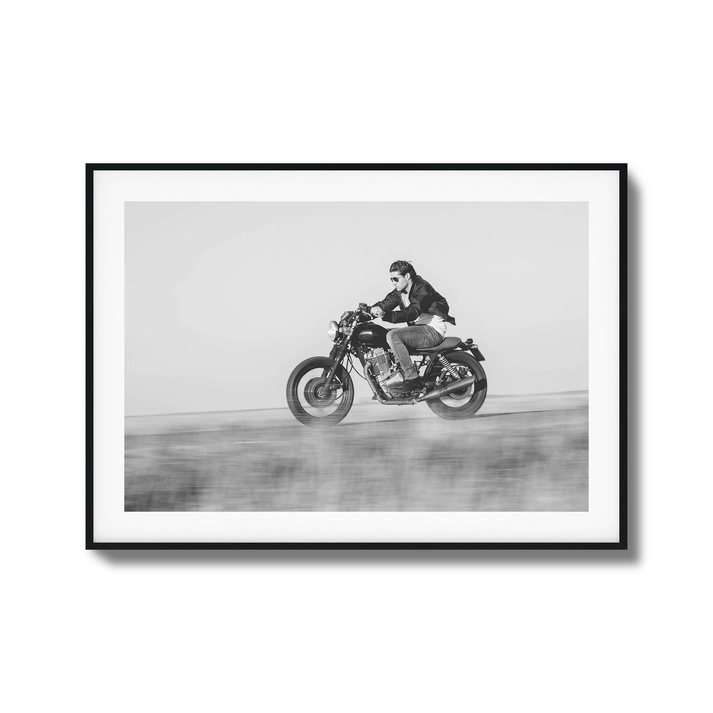 Black-and-white motorcyclist in motion framed art