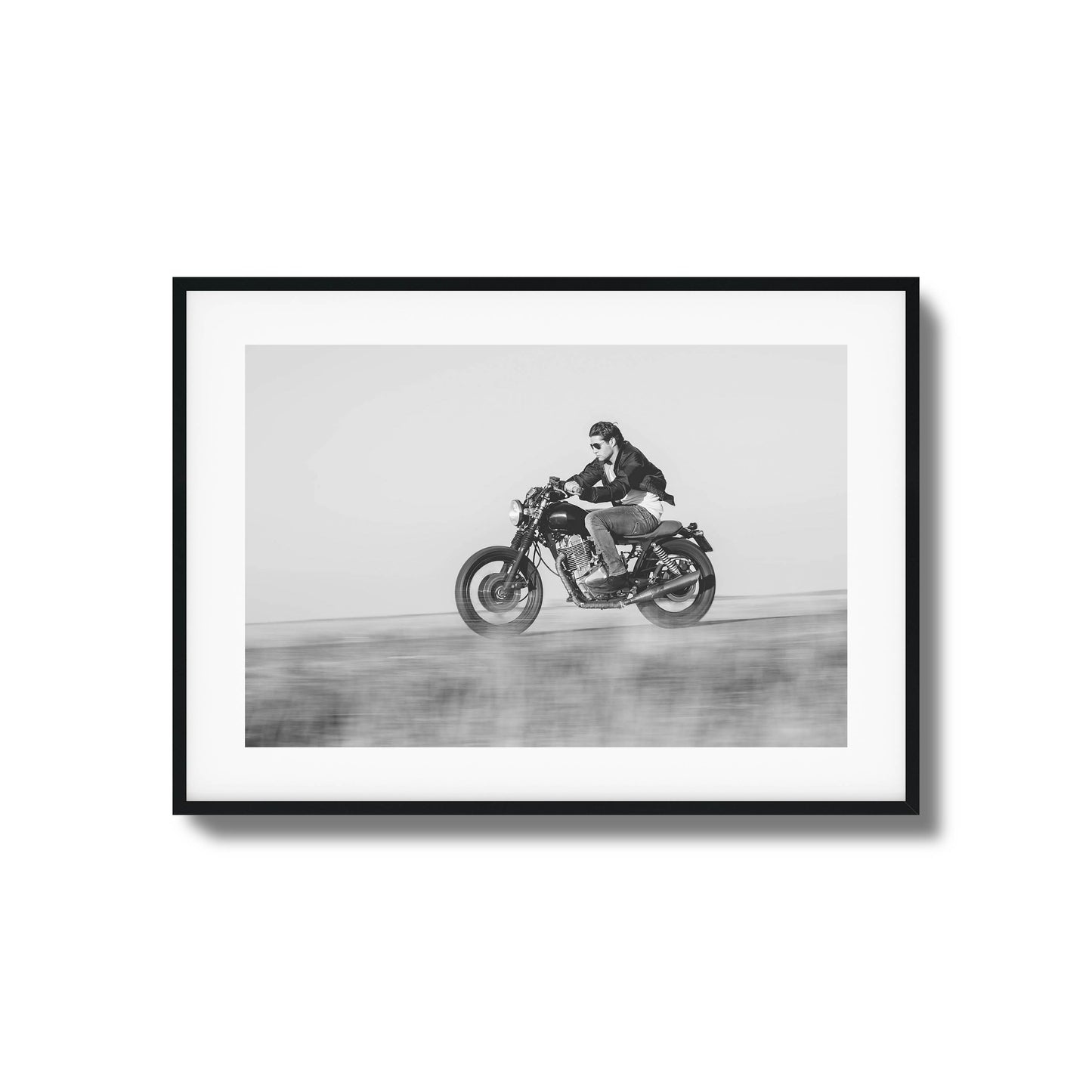 Black-and-white motorcyclist in motion framed art