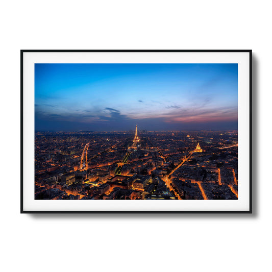 Twilight Paris skyline with the Eiffel Tower glowing.