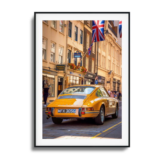 A vintage Porsche in vibrant city surroundings, ideal as framed artwork for a classic touch.