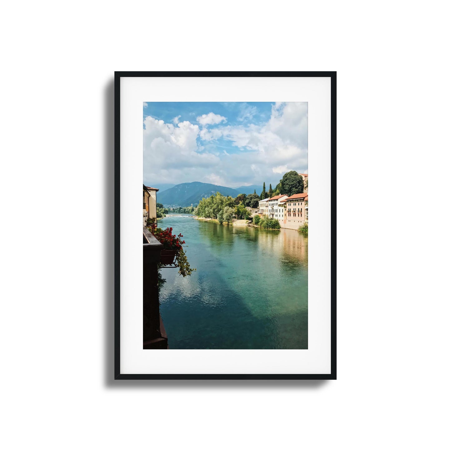 Aqua-blue river lined with colorful buildings and trees