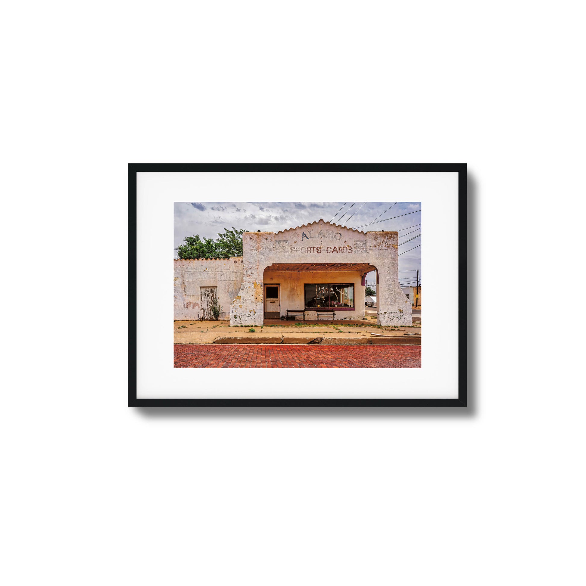 A photo of an abandoned, crumbling building with dramatic lighting, framed artwork.