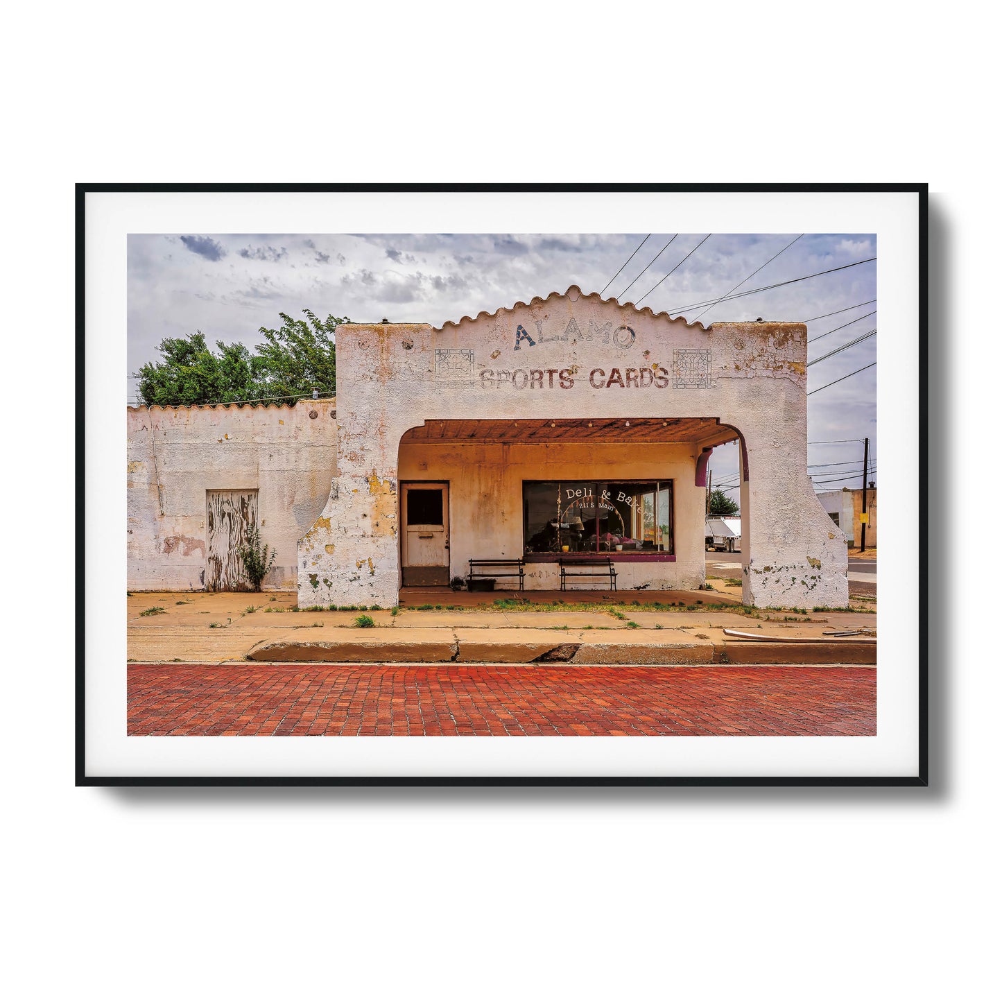 A photo of an abandoned, crumbling building with dramatic lighting, framed artwork.