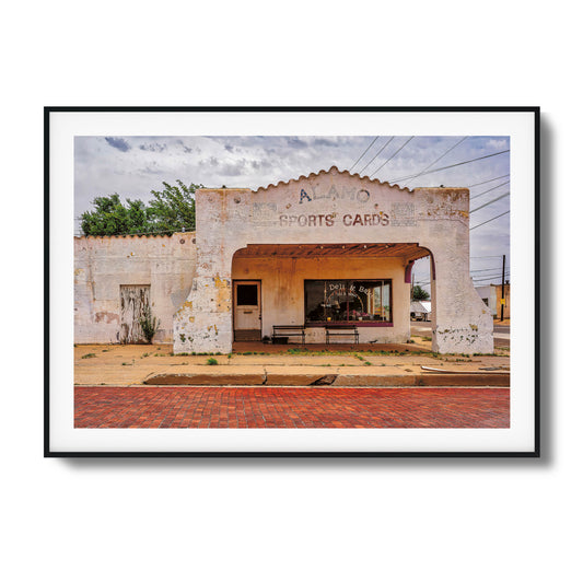 A photo of an abandoned, crumbling building with dramatic lighting, framed artwork.