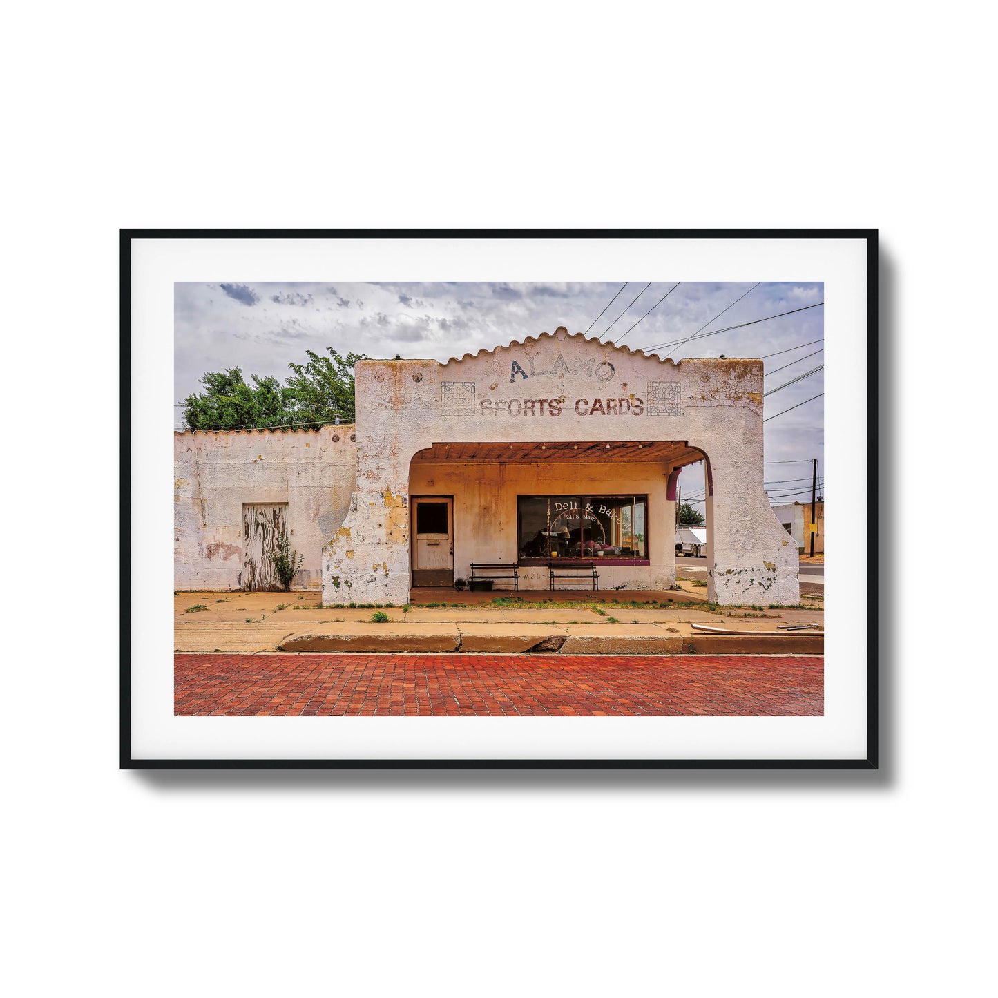 A photo of an abandoned, crumbling building with dramatic lighting, framed artwork.