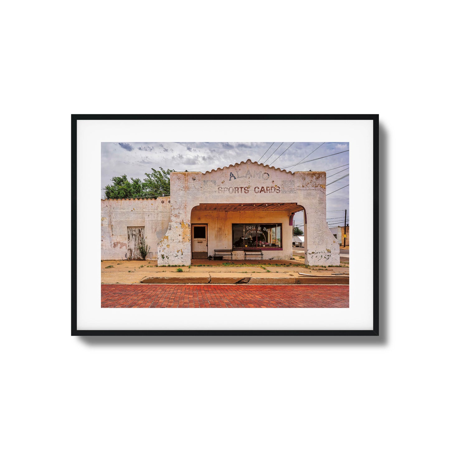 A photo of an abandoned, crumbling building with dramatic lighting, framed artwork.