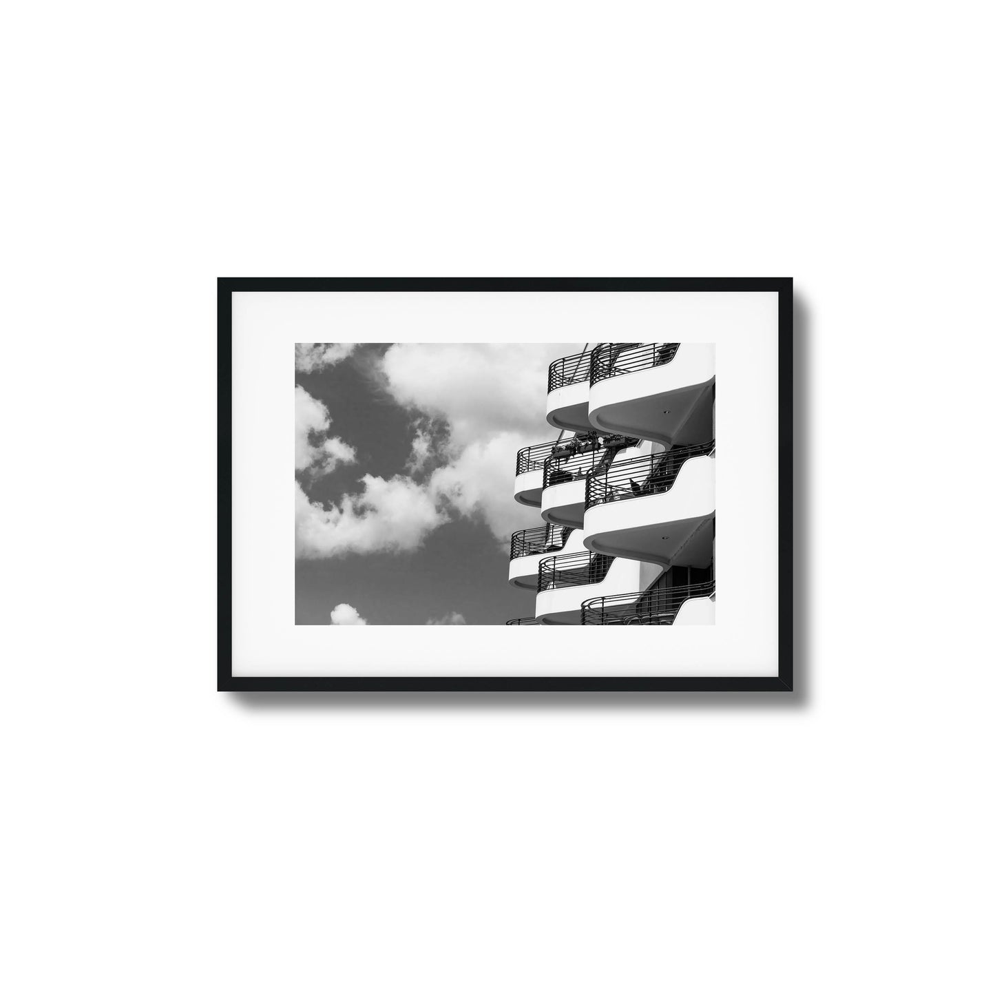 Black-and-white photo of modern balconies and clouds