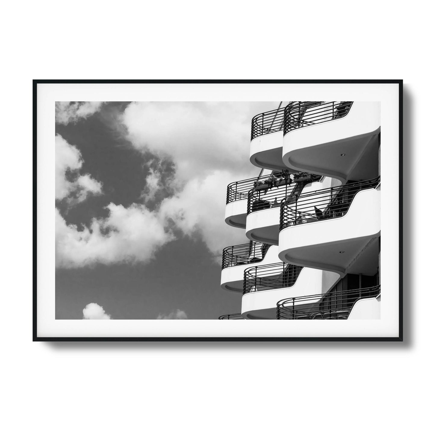 Black-and-white photo of modern balconies and clouds