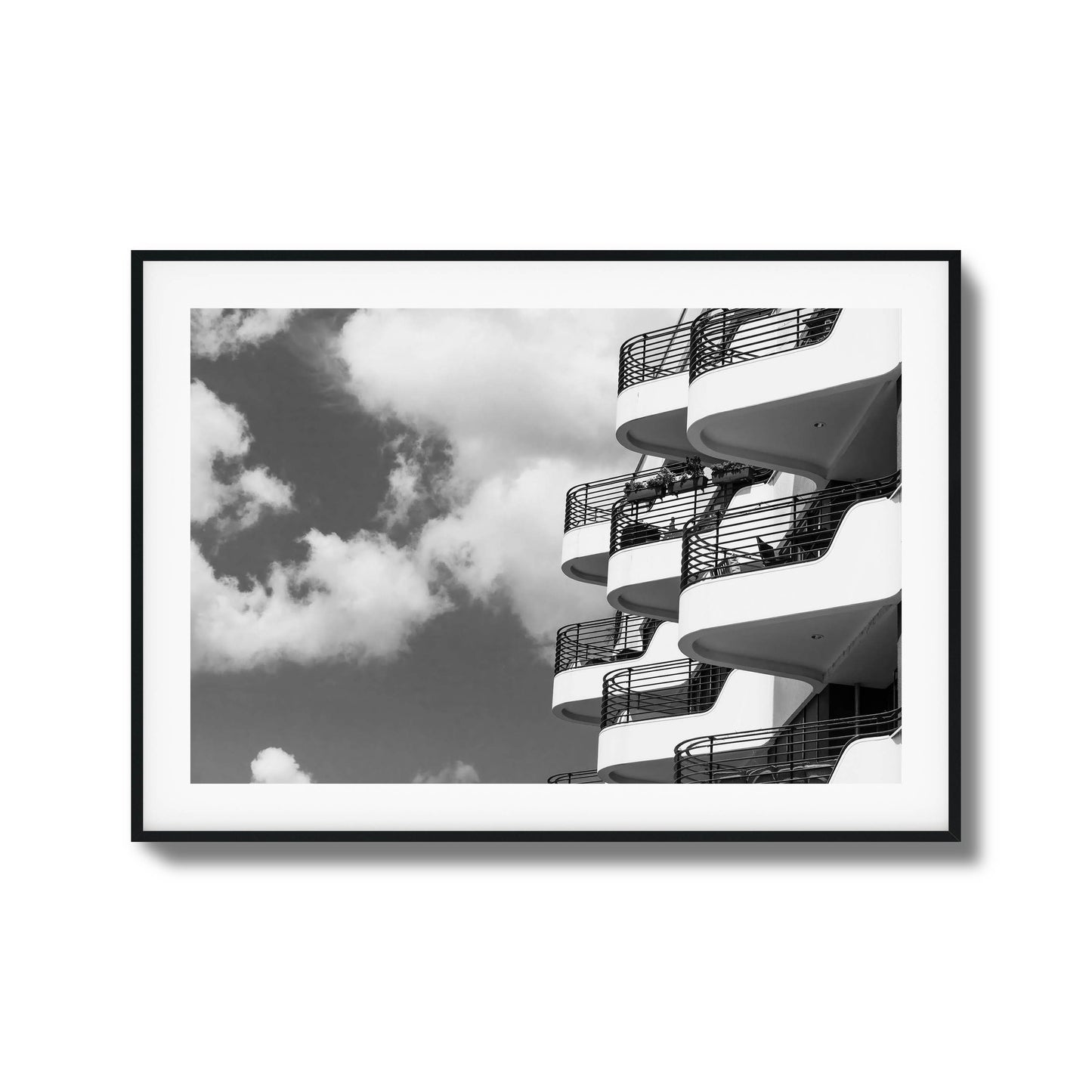 Black-and-white photo of modern balconies and clouds