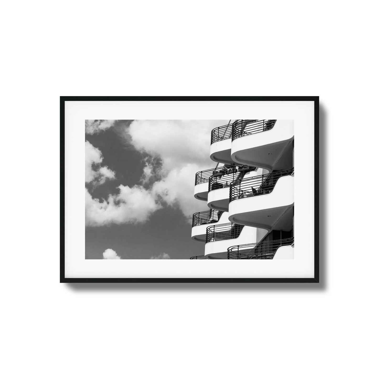 Black-and-white photo of modern balconies and clouds